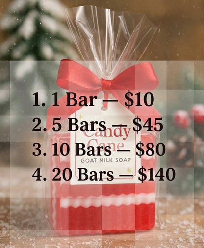 Packaged goat milk soap with a red bow against a snowy background