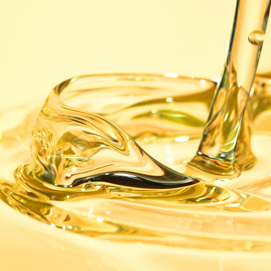 Close-up of golden Beard Oil texture pouring from the dropper — PureButterMelts