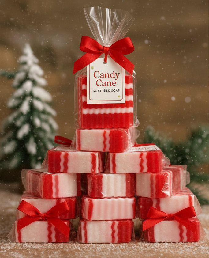 Stack of candy cane-themed soap bars with a red ribbon and 'Candy Cane' label against a snowy background.
