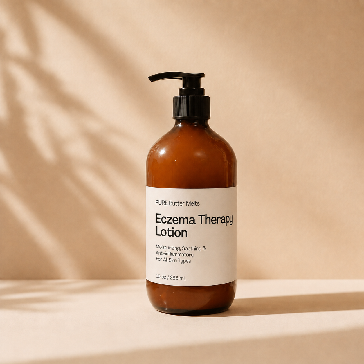 An amber glass pump bottle of Pure Butter Melts Eczema Therapy Lotion with a black pump and white label, set against a warm beige background with soft leaf shadows.