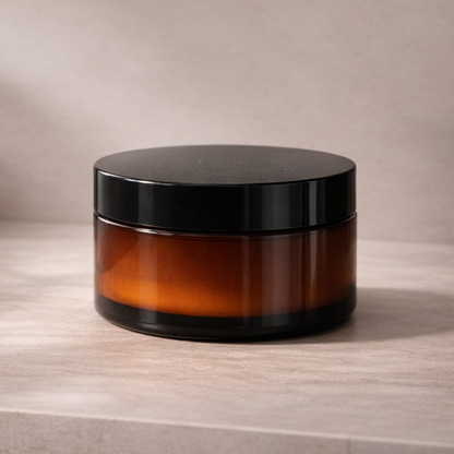 Amber cosmetic jar on neutral studio background representing a curl defining gel for frizz control and humidity resistance.