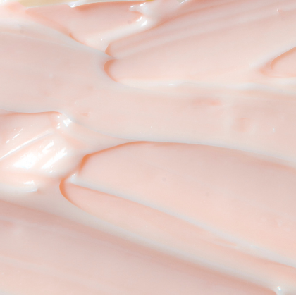 Close-up of smooth, creamy leave-in conditioner with soft peaks and a lightweight lotion texture.