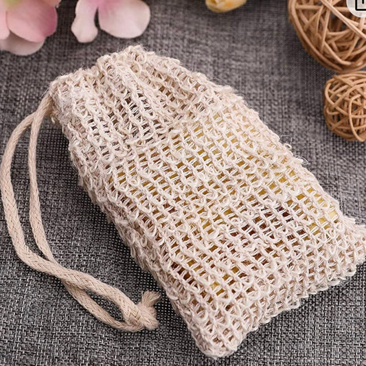 Natural sisal soap pouch, empty, styled with dried flowers and rattan on grey linen — PureButterMelts